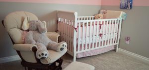 Kids room with baby bed and a recliner