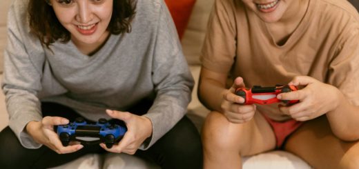 Girls sitting on gaming recliner while playing playstation